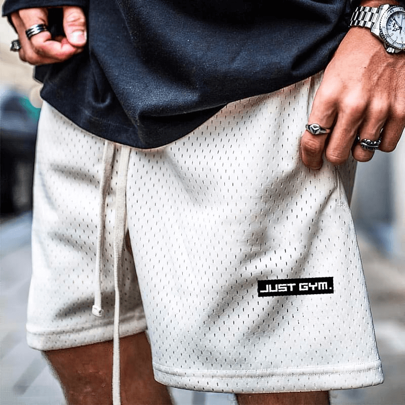 Men's beige mesh running shorts with deep pockets, perfect for gym workouts, featuring 'Just Gym' label.
